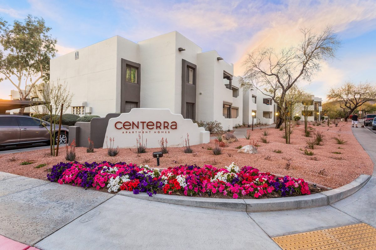 Centerra Apartment Homes entrance sign with flower beds at dusk, Scottsdale